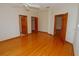 Bright, spacious bedroom with hardwood floors, ceiling fan, and multiple doorways at 2784 Alexander Dr, Clearwater, FL 33763
