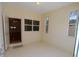 Bright entryway featuring neutral walls, tile floors, and a glass door leading to the main living area at 2784 Alexander Dr, Clearwater, FL 33763