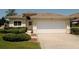 Beautiful one-story home with a two-car garage, well-kept lawn, and attractive landscaping at 2784 Alexander Dr, Clearwater, FL 33763