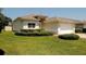 Charming single-story home featuring a well-maintained lawn and manicured bushes at 2784 Alexander Dr, Clearwater, FL 33763