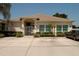 Home exterior featuring an arched entrance, iron gate, and a well-kept front yard at 2784 Alexander Dr, Clearwater, FL 33763