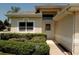 Home exterior with manicured bushes, a walkway, and a white front door under the roofline at 2784 Alexander Dr, Clearwater, FL 33763