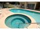 View of the hot tub and swimming pool, surrounded by a brick deck and lounge chairs at 2784 Alexander Dr, Clearwater, FL 33763