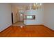 Open-concept living space with gleaming hardwood floors and elegant lighting fixtures at 2784 Alexander Dr, Clearwater, FL 33763