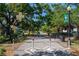 Inviting entrance to Dunedin trail, framed by lush trees, benches, and a quaint railroad crossing sign at 2784 Alexander Dr, Clearwater, FL 33763