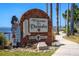 Welcome to Dunedin sign featuring a bagpiper statue, lush greenery and waterfront views at 2784 Alexander Dr, Clearwater, FL 33763