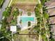 Overhead view of a stunning community pool surrounded by lush landscaping, lounge chairs, and various seating areas at 3236 Barbour Trl, Odessa, FL 33556
