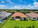 An aerial view showcasing the home's layout, lush green lawn, and neighborhood surroundings, emphasizing its prime location at 3236 Barbour Trl, Odessa, FL 33556