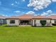 Beautiful backyard featuring a well-maintained lawn and outdoor patio with comfortable seating, perfect for relaxing or entertaining at 3236 Barbour Trl, Odessa, FL 33556
