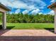 Expansive backyard showcasing a lush green lawn and a line of trees offering plenty of privacy at 3236 Barbour Trl, Odessa, FL 33556