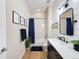 Bright bathroom with a combined shower and tub, offering a single vanity sink, and classic decor at 3236 Barbour Trl, Odessa, FL 33556