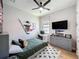 This bedroom includes a ceiling fan, desk, and hockey themed decor at 3236 Barbour Trl, Odessa, FL 33556