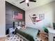 This bedroom includes a ceiling fan, desk, and decorative American Flag and hockey stick at 3236 Barbour Trl, Odessa, FL 33556