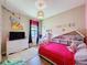 Bright room with unique light fixture, bright bedding, and playful decor at 3236 Barbour Trl, Odessa, FL 33556