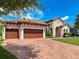 Beautiful home with a paver driveway, two-car garage, well-maintained lawn, and mature landscaping at 3236 Barbour Trl, Odessa, FL 33556