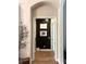Hallway with a modern black accent wall and neutral paint at 3236 Barbour Trl, Odessa, FL 33556