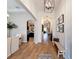 Elegant hallway with wood floors, arched doorways, decorative lighting, and neutral paint colors at 3236 Barbour Trl, Odessa, FL 33556