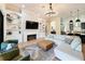 Bright living room featuring a stone fireplace, built-in bookshelves, and a large sectional sofa at 3236 Barbour Trl, Odessa, FL 33556