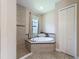 This main bathroom features a soaking tub with tile surround and a tiled shower at 3236 Barbour Trl, Odessa, FL 33556