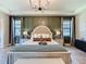 This main bedroom boasts an accent wall, chandelier, and elegant furnishings at 3236 Barbour Trl, Odessa, FL 33556