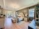 Expansive main bedroom featuring wood floors, tray ceiling, accent wall, and a sitting area at 3236 Barbour Trl, Odessa, FL 33556