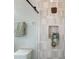 Modern shower featuring stylish neutral tiling, glass door, and an inset shelf at 3236 Barbour Trl, Odessa, FL 33556