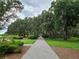 Scenic walking path with mature trees providing ample shade, a great place to walk at 3236 Barbour Trl, Odessa, FL 33556