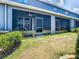 Screened-in patio with seating overlooks well-maintained backyard and lawn at 32977 Kaloko Rd, Wesley Chapel, FL 33543