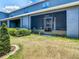 Home's screened-in patio and landscape in the backyard at 32977 Kaloko Rd, Wesley Chapel, FL 33543