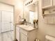 Bathroom with single sink, a vanity mirror, medicine cabinet, and access to the shower and toilet at 32977 Kaloko Rd, Wesley Chapel, FL 33543