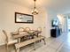 Dining room featuring natural light, tile flooring, and a farmhouse style table at 32977 Kaloko Rd, Wesley Chapel, FL 33543