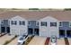 An exterior of modern townhomes with garages and landscaped driveways at 32977 Kaloko Rd, Wesley Chapel, FL 33543