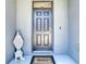 Entryway featuring a black front door, a Welcome mat, and a statue on the stoop at 32977 Kaloko Rd, Wesley Chapel, FL 33543