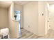 Hallway featuring luxury vinyl plank flooring, white walls, access to the second floor, and an open doorway at 32977 Kaloko Rd, Wesley Chapel, FL 33543