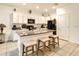 Bright kitchen features an island with granite countertops, white cabinetry, and stainless steel appliances at 32977 Kaloko Rd, Wesley Chapel, FL 33543