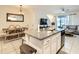 Eat in kitchen and living area featuring granite countertops, tile flooring, and neutral paint at 32977 Kaloko Rd, Wesley Chapel, FL 33543