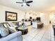 Open-concept living room with stylish decor and white tiled floors at 32977 Kaloko Rd, Wesley Chapel, FL 33543