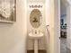 Powder room with pedestal sink, oval mirror, updated vanity lighting, and a tiled floor at 32977 Kaloko Rd, Wesley Chapel, FL 33543