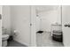 Neutral bathroom featuring a toilet, tile flooring, shower with white curtain, and a granite-look vanity at 33668 Elm Hill Branch, Wesley Chapel, FL 33545