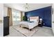Comfortable bedroom features decorative wall, soft carpet, and natural light at 33668 Elm Hill Branch, Wesley Chapel, FL 33545