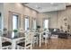 Spacious common room with large windows, comfortable seating, and stylish decor at 33668 Elm Hill Branch, Wesley Chapel, FL 33545