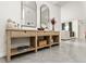 Elegant entryway featuring a console table with decorative mirrors and accents, complementing the tile flooring at 33668 Elm Hill Branch, Wesley Chapel, FL 33545