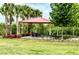 Outdoor gazebo featuring a picnic table and lush landscaping, perfect for relaxing at 33668 Elm Hill Branch, Wesley Chapel, FL 33545
