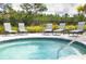 Relaxing hot tub surrounded by lounge chairs, offering a perfect spot to unwind at 33668 Elm Hill Branch, Wesley Chapel, FL 33545