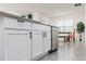 Kitchen featuring stainless steel dishwasher, countertops, and white cabinets at 33668 Elm Hill Branch, Wesley Chapel, FL 33545
