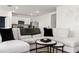 Open living space showcasing a sectional sofa and open floor plan to the kitchen at 33668 Elm Hill Branch, Wesley Chapel, FL 33545