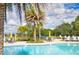 Inviting pool area with umbrella-shaded tables and chairs for relaxing poolside at 33668 Elm Hill Branch, Wesley Chapel, FL 33545