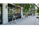 Retail storefront featuring glass garage door style windows and adjacent sidewalk access at 33668 Elm Hill Branch, Wesley Chapel, FL 33545