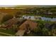 Panoramic aerial view of a beautiful home and community, nestled amongst lush greenery and a tranquil lake at 3895 Mimosa Pl, Palm Harbor, FL 34685