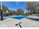 Active basketball court with hoops and seating area, great for recreation at 3895 Mimosa Pl, Palm Harbor, FL 34685